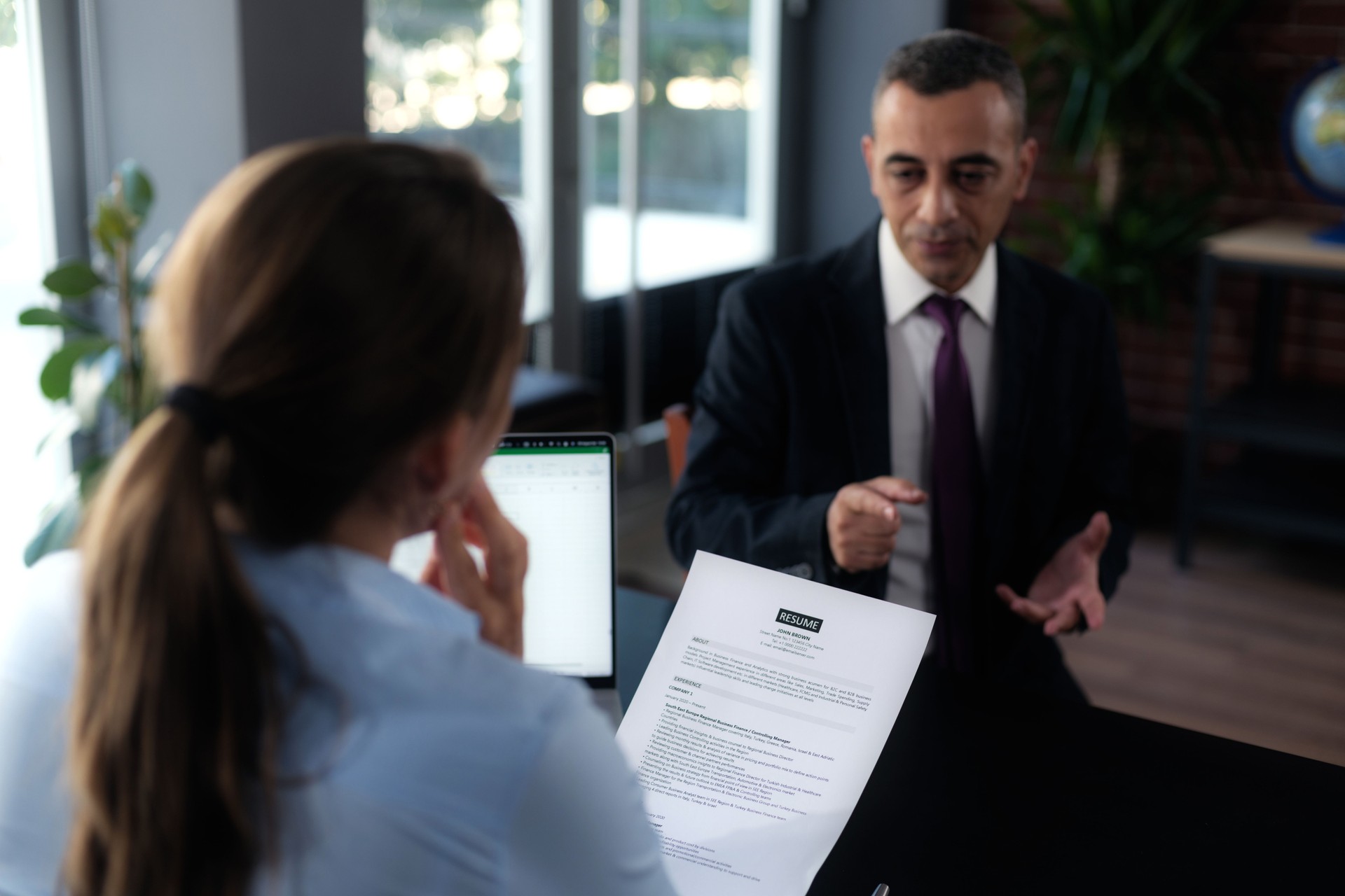 Businesswoman Interviewing Male Job candidate In The Office Meeting Room